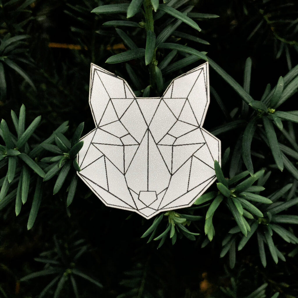 Gray fox reflector with geometric pattern on green background